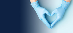 Gloved hand forming a heart shape