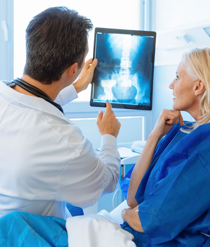 Doctor examining an x-ray with a patient 